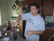 There’s my brother, polishing off a gallon of rum it looks like.....lush. Note the "Drink til you want me" shirt.
