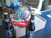 the package John sent me, containing two Lake Louie beers, a bag of skittles and some legos...